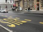 The bus stop on my way to work, where you can see people commuting to work by car, bike and bus!