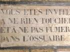 This is the entrance to the Catacombs. It says, "You are invited, Touch nothing and do not smoke in the ossuary" 
