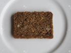 A piece of rye bread where you can see seeds and nuts