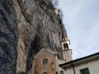 A church on a side of the mountain in Italy