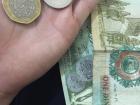 Dinar paper bills, a nos (half dollar) and ten quirsh (cents)