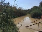 The Jordan River from the West Bank. This river is almost dried up and is mostly controlled by Israel; the water is dirty, but many tourists come to be baptized in it