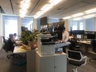 Employees of Citi hard at work, taking phone calls and eating lunch at their desks