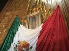 Juan Diego's cloak with the image of the Virgin of Guadalupe is on display in the Basilica of Guadalupe. Millions of people travel to the Basilica to see it. 