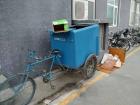 This is our dumpster on wheels. A worker pedals it away every morning to another location to be dumped. 