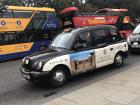 Many of the classic black taxis have advertisements for local attractions on their doors