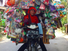 A toy seller carts his wares on a motorbike in Kendari, Southeast Sulawesi