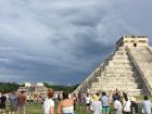 At the base of the pyramid there is a stone carving of Kukulkan's head, and the shadow (on the lefthand side, where my friend Cara is pointing) serves as his body