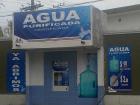 An example of a water refill station, with the typical garrafon pictured on the right, costing only ten pesos!