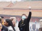 Friend waving at me while wearing a face mask to shield bad air