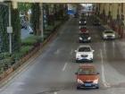 Lots of cars driving under an overpass. I was standing on a walking bridge that goes over road when I took this picture.