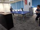 Some employees playing ping-pong in the office during a break