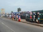 On the big streets in Ghana, people sell goods at stoplights