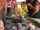 Two women perform puja for Shiva