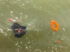 Orange offering flowers in the Ganga River