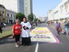 Me with a priest standing in the road just ahead of the procession