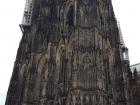 Cologne Cathedral towers over the rest of the city, made of brown and black stone