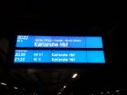 A sign on platform three showing the next train to Karlsruhe