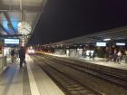 People step forward on the platform as the train nears the station