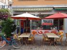 A Döner shop called Dilo's with several dining tables standing outside