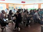 Lots of groups eating together in the cafeteria