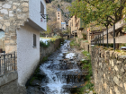 Another stream flowing down between buildings in Andorra la Vella