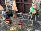 A typical yard scene in Andorra, with cagatíos and other wooden figures
