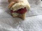 This is a bocadillo (sandwich) with salchichón, a type of sausage.  These small pieces of bread with pieces of sausage inside are a typical snack for the area