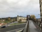 This is an academic building in front of the walking bridge over the highway at the university