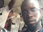 My friend Lamine says "Hello, HWMS" from inside a TATA bus