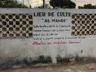 This message basically says, "This place of worship is where the spirit of Seydina Limalou Laye (PBUH) rested for over 1000 years. This is the private property of the Layenne. Land thieves, beware!"