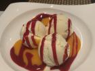 Vanilla ice cream with mango and raspberry sauce