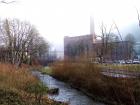 At this small stream in the city center, one can see the fog just beginning to lift over a local factory