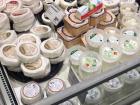 There are many coolers of cheese at grocery stores