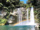 A rainbow cutting across Cheonjiyeon Waterfall.