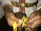 A villager tying my wrist and blessing me with safe travels