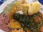 Here is a typical Rwandan meal-- with cassava sauce (the green portion in the middle), a common pea and carrot mix to the right, cabbage cooked in a tomato sauce (toward the bottom of the photo), peanut sauce (far left), roasted pumpkin, and sweet potato!