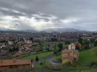 You can see the snow on the mountains in the distance and the dark rain clouds forming over the city