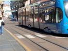 Two modern trams travelling along one of Zagreb's main streets