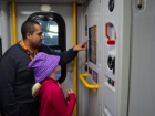 A service worker showing a passenger the routes