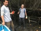 Collecting a mud sample that I will later analyze in the lab