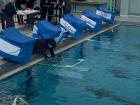 Students placing their ROV through the ice hole