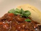 Beef stew with creamed potatoes and roasted root vegetables in rich gravy