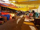 A cow wandering through a fruit market doesn't even draw attention! Just another shopper! 