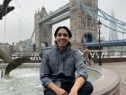 Posing in front of the London Tower, near the River Thames