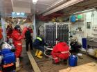 Scientists collecting samples of seawater in many different containers around the CTD rosette (Photo: Pauline Snoeijs Leijonmalm)