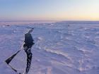 An example of the daily cracks that open in the ice, with Droneville in the distance