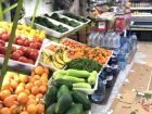 A common market with fruits and vegetables outside 