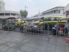 Tuk-tuk cabs lined up outside a market