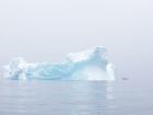 If you look closely, you can spot the tiny kayak next to this huge iceberg